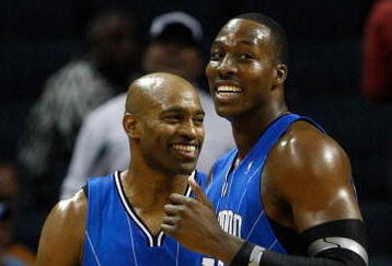 CHARLOTTE, NC - NOVEMBER 10:  Teammates Vince Carter #15 and Dwight Howard #12 of the Orlando Magic smile as they look over at the bench against the Charlotte Bobcats during their game at Time Warner Cable Arena on November 10, 2009 in Charlotte, North Carolina.  (Photo by Streeter Lecka/Getty Images)