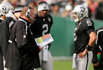 OAKLAND, CA - NOVEMBER 22:  Oakland Raiders head coach Tom Cable speaks to his new starting quarterback Bruce Gradkowski #5 while newly benched quarterback JaMarcus Russell #2 looks on during their game against the Cincinnati Bengals at Oakland-Alameda County Coliseum on November 22, 2009 in Oakland, California.  (Photo by Ezra Shaw/Getty Images)