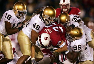 PALO ALTO, CA - NOVEMBER 26:  Nick Frank #35 of Stanford is tackled by Victor Abiamiri #95,Corey Mays #46, and Brandon Hoyte #39 of Notre Dame at a game at Stanford University on November 26, 2005 in Palo Alto, California.  (Photo by Jed Jacobsohn/Getty Image