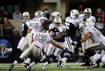 ARLINGTON, TX - NOVEMBER 26:  Running back Felix Jones #28 of the Dallas Cowboys runs the ball against Tyvon Branch #33 of the Oakland Raiders at Cowboys Stadium on November 26, 2009 in Arlington, Texas.  (Photo by Ronald Martinez/Getty Images)