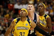 BOISE, ID - MARCH 20:  Forward Gary Wilkinson #55 of the Utah State Aggies is guarded by forwards Lazar Hayward #32 and Jimmy Butler #33 of the Marquette Golden Eagles during the first round of the NCAA Division I Men's Basketball Tournament at the Taco Bell Arena on March 20, 2009 in Boise, Idaho.  (Photo by Jed Jacobsohn/Getty Images)