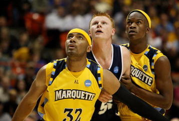 BOISE, ID - MARCH 20:  Forward Gary Wilkinson #55 of the Utah State Aggies is guarded by forwards Lazar Hayward #32 and Jimmy Butler #33 of the Marquette Golden Eagles during the first round of the NCAA Division I Men's Basketball Tournament at the Taco Bell Arena on March 20, 2009 in Boise, Idaho.  (Photo by Jed Jacobsohn/Getty Images)