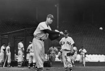 BOSTON, MA - CIRCA 1945:  (UNDATED FILE PHOTO)  Baseball legend Ted Williams (1919 - 2002) of the Boston Red Sox swings a bat at a ball during a pre-game practice as Walter 'Smokey' Baker, the 13-year-old son of Red Sox pitching coach Del Baker (1892 - 1973), watches circa 1945 in Boston, Massachusetts. Williams, 83-years-old, was pronounced dead July 5, 2002 at Citrus County Memorial Hospital in Florida. Williams died of an apparent heart attack.  (Photo by Getty Images)