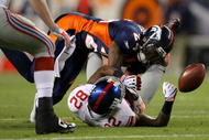 DENVER - NOVEMBER 26: Wide receiver Mario Manningham #82 of the New York Giants is unable to make a reception as he is hit by Champ Bailey #24 of the Denver Broncos during NFL action at Invesco Field at Mile High on November 26, 2009 in Denver, Colorado. (Photo by Doug Pensinger/Getty Images)