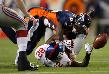 DENVER - NOVEMBER 26:  Wide receiver Mario Manningham #82 of the New York Giants is unable to make a reception as he is hit by Champ Bailey #24 of the Denver Broncos during NFL action at Invesco Field at Mile High on November 26, 2009 in Denver, Colorado.  (Photo by Doug Pensinger/Getty Images)
