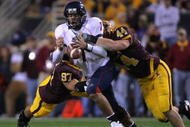 TEMPE, AZ - DECEMBER 01:  Willie Tuitama #7 of the University of Arizona Wildcats fumbles the ball as he is tackled by Travis Goethel #44 and Luis Vasquez #97 of the Arizona State University Sun Devils during the second quarter at Sun Devil Stadium on December 1, 2007 in Tempe, Arizona.  (Photo by Harry How/Getty Images)  