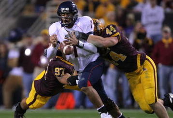 TEMPE, AZ - DECEMBER 01:  Willie Tuitama #7 of the University of Arizona Wildcats fumbles the ball as he is tackled by Travis Goethel #44 and Luis Vasquez #97 of the Arizona State University Sun Devils during the second quarter at Sun Devil Stadium on December 1, 2007 in Tempe, Arizona.  (Photo by Harry How/Getty Images)  