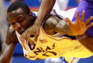 LAWRENCE, KS - NOVEMBER 27:  Tyshawn Taylor #10 of the Kansas Jayhawks dives to try to steal the ball from Zach Bailey #42 of the Tennessee Tech Golden Eagles during the game on November 27, 2009 at Allen Fieldhouse in Lawrence, Kansas.  (Photo by Jamie Squire/Getty Images)