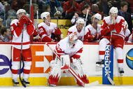 MONTREAL- NOVEMBER 21:  Jimmy Howard #35 of the Detroit Red Wings waits with team mates Pavel Datsyuk #13 and Brad Stuart #23 for the shootout round to begin during the NHL game against the Montreal Canadiens on November 21, 2009 at the Bell Centre in Montreal, Quebec, Canada.  The Red Wings defeated the Canadiens 3-2 in a shootout.  (Photo by Richard Wolowicz/Getty Images)