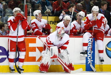 MONTREAL- NOVEMBER 21:  Jimmy Howard #35 of the Detroit Red Wings waits with team mates Pavel Datsyuk #13 and Brad Stuart #23 for the shootout round to begin during the NHL game against the Montreal Canadiens on November 21, 2009 at the Bell Centre in Montreal, Quebec, Canada.  The Red Wings defeated the Canadiens 3-2 in a shootout.  (Photo by Richard Wolowicz/Getty Images)