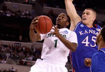 INDIANAPOLIS - MARCH 27:  Kalin Lucas #1 of the Michigan State Spartans drives for a shot attempt against Cole Aldrich #45 of the Kansas Jayhawks during the third round of the NCAA Division I Men's Basketball Tournament at the Lucas Oil Stadium on March 27, 2009 in Indianapolis, Indiana.  (Photo by Andy Lyons/Getty Images)