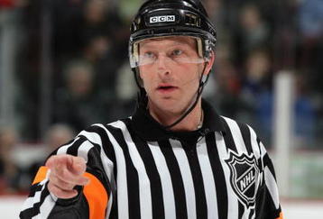 VANCOUVER, CANADA - DECEMBER 17:  NHL Referee Brad Meier makes a pointing gesture during the NHL game between the Vancouver Canucks and the Edmonton Oilers at General Motors Place on December 17, 2005 in Vancouver, British Columbia, Canada.  The Oilers defeated the Canucks 5-4 in overtime. (Photo by Jeff Vinnick/Getty Images)