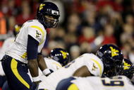 CINCINNATI - NOVEMBER 13: Quarterback Jarrett Brown #16 of the West Virginia Mountaineers calls out a play against the Cincinnati Bearcats in the first quarter of the game at Nippert Stadium on November 13, 2009 in Cincinnati, Ohio. (Photo by Andy Lyons/Getty Images)