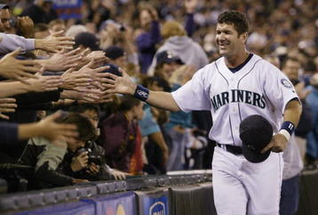 SEATTLE - OCTOBER 2:  Edgar Martinez #11 of the Seattle Mariners is greeted by fans as he takes a lap around the field during a post game ceremony honoring his career as a Mariner on October 2 2004 at Safeco Field in Seattle, Washington.   (Photo by Otto Greule Jr/Getty Images)