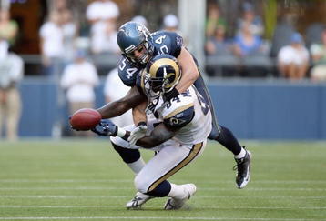 SEATTLE, WA - SEPTEMBER 13:  Randy McMichael #84 of the St. Louis Rams is tackled by Will Herring #54 of the Seattle Seahawks on September 13, 2009 at Qwest Field in Seattle, Washington. The Seahawks defeated the Rams 28-0. (Photo by Otto Greule Jr/Getty Images) 