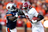AUBURN, AL - NOVEMBER 27: Julio Jones #8 of the Alabama Crimson Tide tries to break a tackle by Jonathan Evans #35 of the Auburn Tigers at Jordan-Hare Stadium on November 27, 2009 in Auburn, Alabama. (Photo by Kevin C. Cox/Getty Images)
