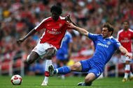 LONDON - MAY 10:  Emmanuel Adebayor of Arsenal is tackled by Branislav Ivanovic of Chelsea during the Barclays Premier League match between Arsenal and Chelsea at the Emirates Stadium on May 10, 2009 in London, England.  (Photo by Jamie McDonald/Getty Images)