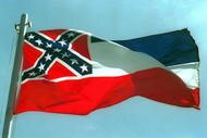 387975 02:  The Mississippi State flags flies April 17, 2001 in Pascagoula, MS. Voters will decide whether to replace the state's old flag, which sports the Confederate battle cross, with a new flag that would have 20 white stars on a blue square.  (Photo by Bill Colgin/Getty Images) 