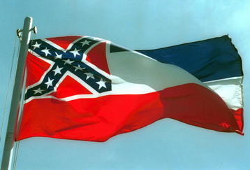 387975 02:  The Mississippi State flags flies April 17, 2001 in Pascagoula, MS. Voters will decide whether to replace the state's old flag, which sports the Confederate battle cross, with a new flag that would have 20 white stars on a blue square.  (Photo by Bill Colgin/Getty Images) 