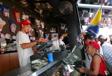 INDIANAPOLIS - AUGUST 06:  Fans shop at the 'Talladega Nights: The Ballad of Ricky Bobby' souvenir stand prior to the NASCAR Nextel Cup Series Allstate 400 at the Brickyard on August 6, 2006 at Indianapolis Motor Speedway in Indianapolis, Indiana.  (Photo by Matthew Stockman/Getty Images for NASCAR)