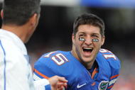 GAINESVILLE, FL - NOVEMBER 21: Quarterback Tim Tebow #15 of the Florida Gators laughs with coach Urban Meyer against the Florida International University Golden Panthers, November 21, 2009 at Ben Hill Griffin Stadium in Gainesville, Florida.  (Photo by Al Messerschmidt/Getty Images)