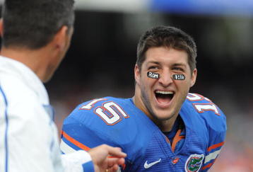 GAINESVILLE, FL - NOVEMBER 21: Quarterback Tim Tebow #15 of the Florida Gators laughs with coach Urban Meyer against the Florida International University Golden Panthers, November 21, 2009 at Ben Hill Griffin Stadium in Gainesville, Florida.  (Photo by Al Messerschmidt/Getty Images)