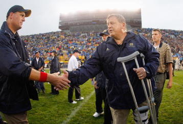 SOUTH BEND, IN - SEPTEMBER 13: Head coach Charlie Weis of the Notre Dame Fighting Irish shakes hands after a 35-17 victory with head coach Rich Rodriguez of the Michigan Wolverines on September 13, 2008 at Notre Dame Stadium in South Bend, Indiana. (Photo by Gregory Shamus/Getty Images)