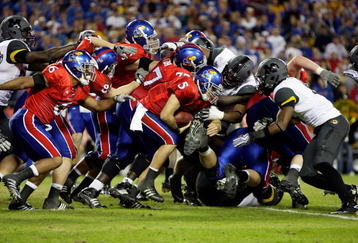 KANSAS CITY, MO - NOVEMBER 28:  Quarterback Todd Reesing #5 of the Kansas Jayhawks carries the ball on a keeper during the game against the Missouri Tigers at Arrowhead Stadium on November 28, 2009 in Kansas City, Missouri.  (Photo by Jamie Squire/Getty Images)