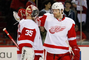 MONTREAL- NOVEMBER 21:  Brad Stuart #23 celebrates with Jimmy Howard #35 of the Detroit Red Wings after defeating the Montreal Canadiens 3-2 in shootouts in the NHL game on November 21, 2009 at the Bell Centre in Montreal, Quebec, Canada.  The Red Wings defeated the Canadiens 3-2 in a shootout.  (Photo by Richard Wolowicz/Getty Images)