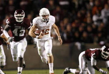 COLLEGE STATION, TX - NOVEMBER 26: Quarterback Colt McCoy #12 of the Texas Longhorns scrambles away from the Texas A&M Aggies defense to score a touchdown in the first half at Kyle Field on November 26, 2009 in College Station, Texas.  (Photo by Aaron M. Sprecher/Getty Images)