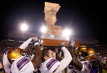 BATON ROUGE, LA - NOVEMBER 28:  Members of the LSU Tigers celebrate with 'The Boot' trophy after defeating the Arkansas Razorbacks 33-30 in overtime at Tiger Stadium on November 28, 2009 in Baton Rouge, Louisiana.  (Photo by Chris Graythen/Getty Images)