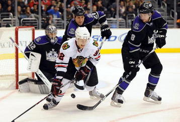 LOS ANGELES, CA - NOVEMBER 28:  Kris Versteeg #32 of the Chicago Black Hawks tries to control a rebound in front of Drew Doughty #8, Jarret Stoll #28 and Jonathan Quick #32 of the Los Angeles Kings during the first period at the Staples Center on November 28, 2009 in Los Angeles, California.  (Photo by Harry How/Getty Images)