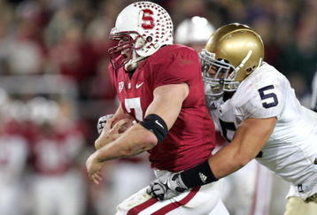 PALO ALTO, CA - NOVEMBER 28:  Toby Gerhart #7 of the Stanford Cardinal is tackled by Manti Te'o #5 of the Notre Dame Fighting Irish at Stanford Stadium on November 28, 2009 in Palo Alto, California.  (Photo by Ezra Shaw/Getty Images)