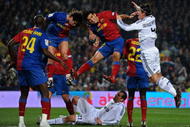 BARCELONA, SPAIN - DECEMBER 13:  Rafael Marquez (2nd R) and Carles Puyol (2nd L) of Barcelona fight for the ball with Sergio Ramos (R) of Real Madrid as Ramos his teammate Christoph Metzelder (Bottem C) lays on the pitch during the La Liga match between Barcelona and Real Madrid at the Camp Nou Stadium on December 13, 2008 in Barcelona, Spain.  (Photo by Jasper Juinen/Getty Images)