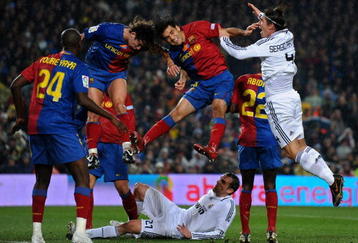 BARCELONA, SPAIN - DECEMBER 13:  Rafael Marquez (2nd R) and Carles Puyol (2nd L) of Barcelona fight for the ball with Sergio Ramos (R) of Real Madrid as Ramos his teammate Christoph Metzelder (Bottem C) lays on the pitch during the La Liga match between Barcelona and Real Madrid at the Camp Nou Stadium on December 13, 2008 in Barcelona, Spain.  (Photo by Jasper Juinen/Getty Images)