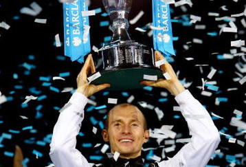 LONDON, ENGLAND - NOVEMBER 29:  Nikolay Davydenko of Russia holds the trophy as he celebrates winning the men's singles final match against Juan Martin Del Potro of Argentina during the Barclays ATP World Tour Finals at the O2 Arena on November 29, 2009 in London, England.  (Photo by Julian Finney/Getty Images)