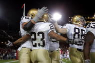 PALO ALTO, CA - NOVEMBER 28:  Golden Tate #23 of the Notre Dame Fighting Irish is congratulated by teammates after he scored a touchdown during their game against the Stanford Cardinal at Stanford Stadium on November 28, 2009 in Palo Alto, California.  (Photo by Ezra Shaw/Getty Images)