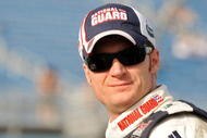 HOMESTEAD, FL - NOVEMBER 20:  Dale Earnhardt Jr., driver of the #88 National Guard/AMP Energy Chevrolet, stands on the grid during qualifying for the NASCAR Sprint Cup Series Ford 400 at Homestead-Miami Speedway on November 20, 2009 in Homestead, Florida.  (Photo by John Harrelson/Getty Images for NASCAR)