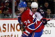 MONTREAL- NOVEMBER 24:  Sergei Kostitsyn #74 of the Montreal Canadiens stick handles the puck while being defended by Rostislav Klesla #97 of the Columbus Blue Jackets during the NHL game on November 24, 2009 at the Bell Centre in Montreal, Quebec, Canada.  The Canadiens defeated the Blue Jackets 5-3.  (Photo by Richard Wolowicz/Getty Images)