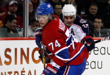 MONTREAL- NOVEMBER 24:  Sergei Kostitsyn #74 of the Montreal Canadiens stick handles the puck while being defended by Rostislav Klesla #97 of the Columbus Blue Jackets during the NHL game on November 24, 2009 at the Bell Centre in Montreal, Quebec, Canada.  The Canadiens defeated the Blue Jackets 5-3.  (Photo by Richard Wolowicz/Getty Images)