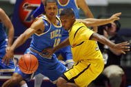 ANAHEIM, CA - NOVEMBER 29:  Stephan Gilling #33 of Long Beach State loses the ball on the dribble drive to the basket as Mustafa Abdul-Hamid #10 of UCLA defends in the first half during the 76 Classic at Anaheim Convention Center on November 29, 2009 in Anaheim, California.  (Photo by Victor Decolongon/Getty Images)