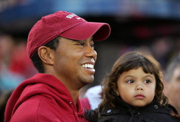 PALO ALTO, CA - NOVEMBER 21:  Honorary Standford Cardinal captain Tiger Woods holds his daugher, Sam, on the sidelines before the Cardinal game against the California Bears at Stanford Stadium on November 21, 2009 in Palo Alto, California.  (Photo by Ezra Shaw/Getty Images)