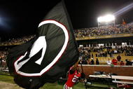 ATLANTA - NOVEMBER 28:  Prince Miller #23 of the Georgia Bulldogs runs with their flag around the stadium after their 30-24 win over the Georgia Tech Yellow Jackets at Bobby Dodd Stadium on November 28, 2009 in Atlanta, Georgia.  (Photo by Kevin C. Cox/Getty Images)