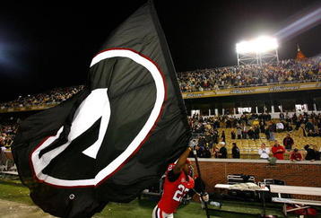 ATLANTA - NOVEMBER 28:  Prince Miller #23 of the Georgia Bulldogs runs with their flag around the stadium after their 30-24 win over the Georgia Tech Yellow Jackets at Bobby Dodd Stadium on November 28, 2009 in Atlanta, Georgia.  (Photo by Kevin C. Cox/Getty Images)