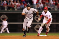 PHILADELPHIA - NOVEMBER 01:  Johnny Damon #18 (L) of the New York Yankees advances to third base after he stole second base in the top of the ninth inning against Pedro Feliz #7 of the Philadelphia Phillies in Game Four of the 2009 MLB World Series at Citizens Bank Park on November 1, 2009 in Philadelphia, Pennsylvania.  (Photo by Al Bello/Getty Images)