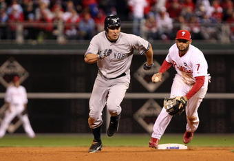 PHILADELPHIA - NOVEMBER 01:  Johnny Damon #18 (L) of the New York Yankees advances to third base after he stole second base in the top of the ninth inning against Pedro Feliz #7 of the Philadelphia Phillies in Game Four of the 2009 MLB World Series at Citizens Bank Park on November 1, 2009 in Philadelphia, Pennsylvania.  (Photo by Al Bello/Getty Images)