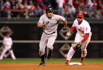 PHILADELPHIA - NOVEMBER 01:  Johnny Damon #18 (L) of the New York Yankees advances to third base after he stole second base in the top of the ninth inning against Pedro Feliz #7 of the Philadelphia Phillies in Game Four of the 2009 MLB World Series at Citizens Bank Park on November 1, 2009 in Philadelphia, Pennsylvania.  (Photo by Al Bello/Getty Images)