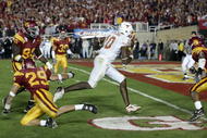 PASADENA, CA - JANUARY 04:  Vince Young #10 of the Texas Longhorns rushes past Frostee Rucker #90, Scott Ware #29 and Josh Pinkard #36 of the USC Trojans to score a 2 point conversion following his touchdown in the final moments of the BCS National Championship Rose Bowl Game at the Rose Bowl on January 4, 2006 in Pasadena, California.  Texas defeated USC 41-38.  (Photo by Harry How/Getty Images)