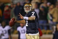 SOUTH BEND, IN - NOVEMBER 21: Jimmy Clausen #7 of the Notre Dame Fighting Irish looks for a receiver in the first overtime period against the Univeristy of Connecticut Huskies at Notre Dame Stadium on November 21, 2009 in South Bend, Indiana. Connecticut defeated Notre Dame 33-30 in double overtime. (Photo by Jonathan Daniel/Getty Images)