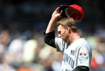 NEW YORK - JULY 04:  Roy Halladay #32 of the Toronto Blue Jays removes his hat against the New York Yankees on July 4, 2009 at Yankee Stadium in the Bronx borough of New York City.  (Photo by Nick Laham/Getty Images)